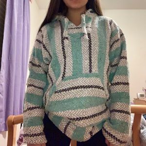 teal, black, and white striped drug rug